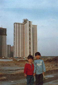 Two kids in front of a building at Co-op City