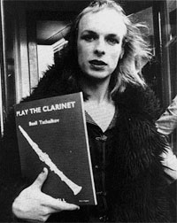 Brian Eno holding clarient instruction book.