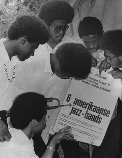 Members of the Kashmere Stage Band with promotional poster.