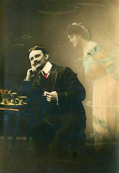A daydreaming gentleman; from an original 1912 postcard published in Germany.